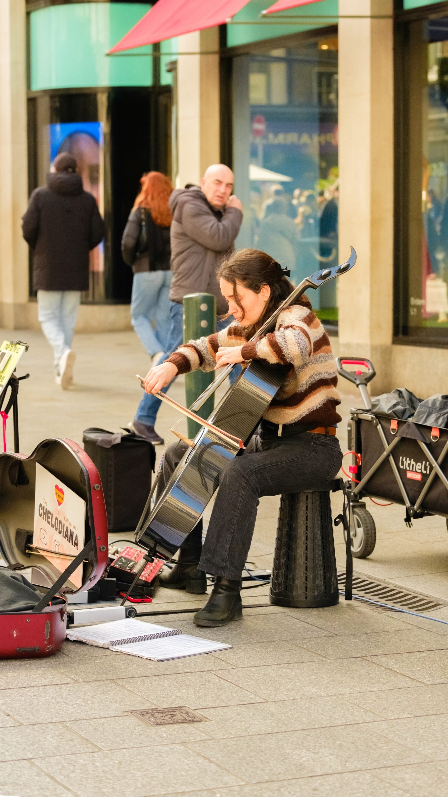 Street cellist performing in Dublin City centre during the afternoon.